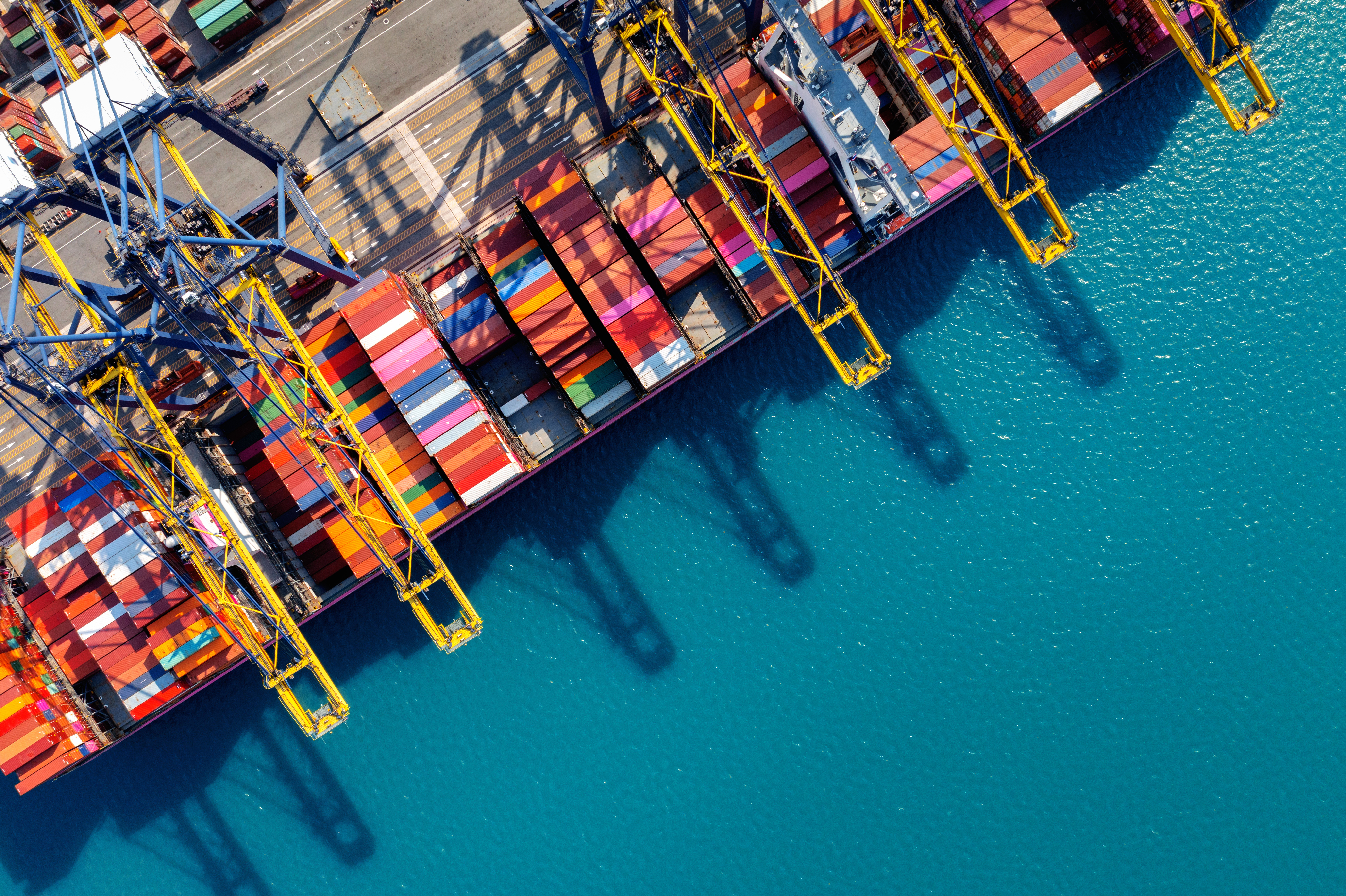 Aerial view of cargo ship and cargo container in harbor